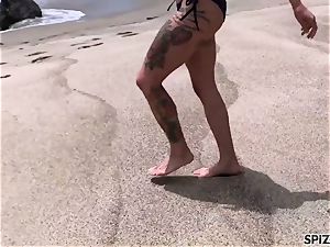 Anna Bell Peaks pummeling a ginormous bone on the beach
